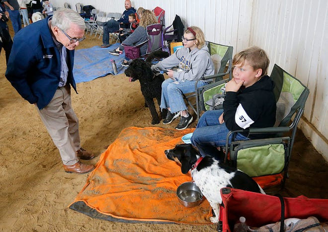 Governor Mike Dewine talks with Mallory Legg and Carter Reisinger at the 4-H dog show as he visited the Ashland County Fair on Saturday.