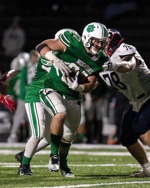 Mogadore senior Mason Williams tries to elude Warren JFK defender Patrick Valent during Friday night's game at Mogadore. Williams has committed to play college football at Ohio University, while Valent is a Rice commit.