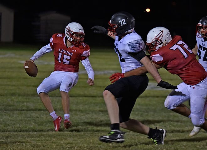 Loving's Kaleb Rodriguez (left) evades a potential tackle from New Mexico Military's Samuel McMargish as Loving's Eduardo De La Cruz attempts to prevent a tackle during the Falcon's Sept. 23, 2022 homecoming game.