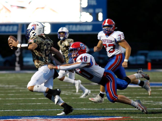 Zanesville's Drew Doyle is chased by Licking Valley's Bryce Justice during the Panthers' 33-7 win on Friday night at John D. Sulsberger Memorial Stadium.