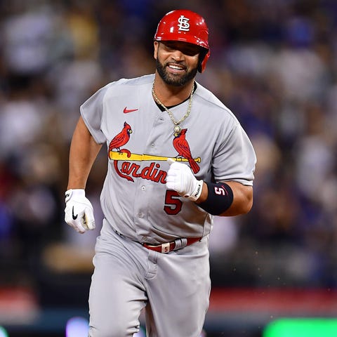 Albert Pujols smiles as he rounds the bases after 
