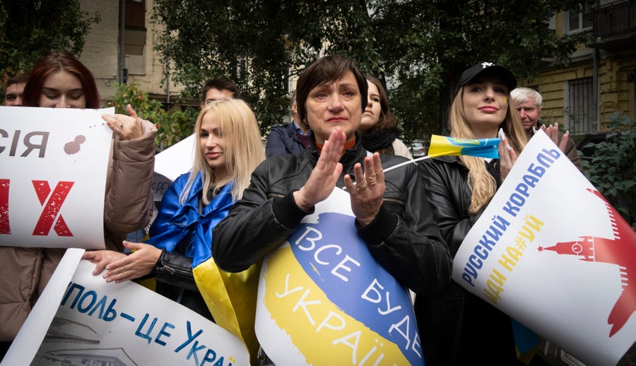 Residents of Mariupol hold a rally against a Kremlin-orchestrated referendum in Kyiv, Ukraine, Saturday, Sept. 24, 2022. Banner reads: "Mariupol is Ukraine". Voting began Friday in four Moscow-held regions of Ukraine on referendums to become part of Russia.