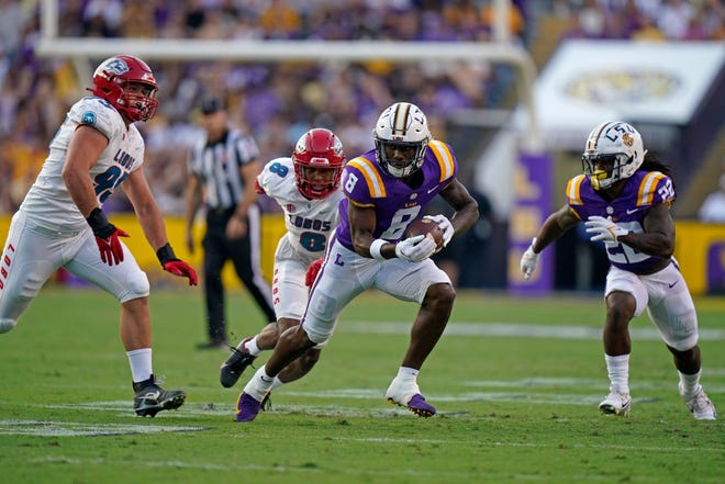 LSU wide receiver Malik Nabers (8) catches a pass against New Mexico defensive end Jake Saltonstall (95) and cornerback Donte Martin (8) in the first half of an NCAA college football game in Baton Rouge, La., Saturday, Sept. 24, 2022. (AP Photo/Gerald Herbert)