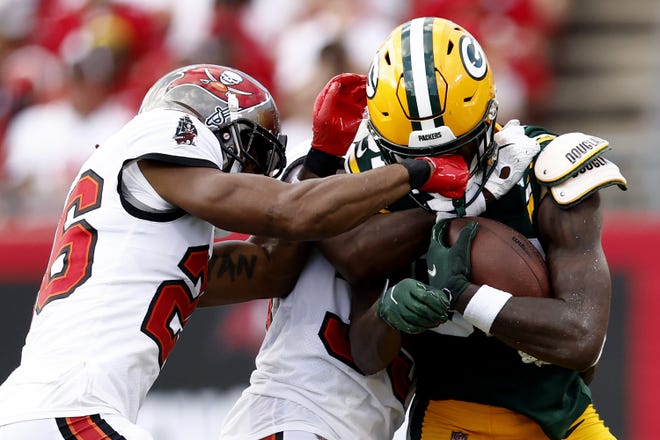 Packers wide receiver Romeo Doubs is defended by Logan Ryan (26) and Jamel Dean (35) during the third quarter in the game on Sept. 25, 2022, at Raymond James Stadium in Tampa, Florida.