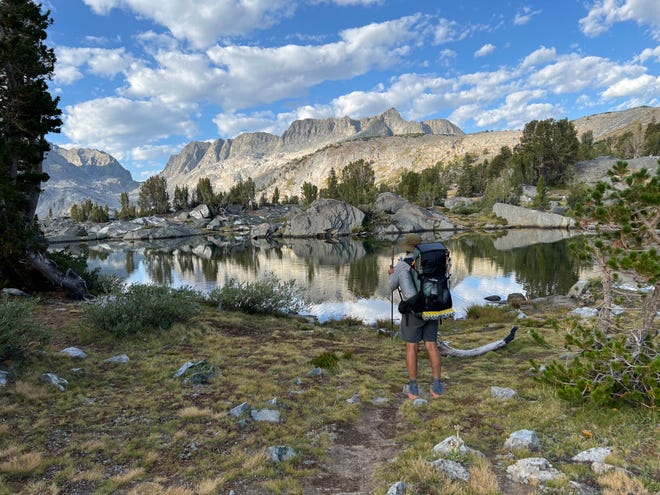 David DeLong, while hiking the John Muir Trail with Mark Woods, looks at a view in the Ansel Adams Wilderness.