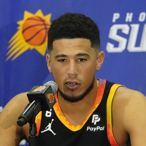 Suns shooting guard Devin Booker speaks during a p