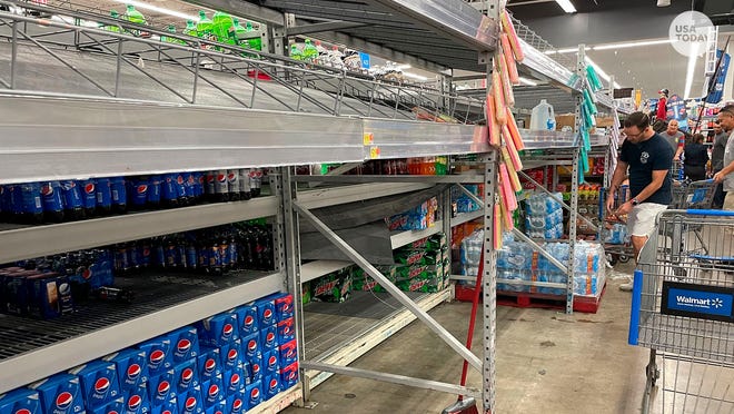 Shoppers go for what was left of the water on the shelves in Tampa, Fla., as Tropical Storm Ian threatened to impact the Tampa Bay as a major hurricane later in the week.