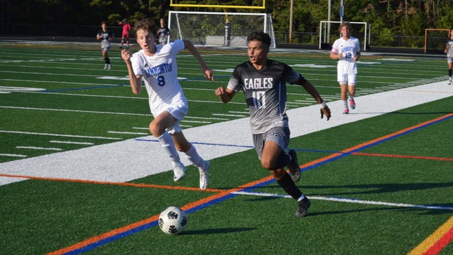 Egg Harbor Township's Lucas Lainez (10) brings the ball forward out of the midfield with Matthew Smith of Hammonton in pursuit.