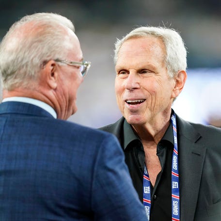 New York Giants co-owner Steve Tisch, right, on the field before the Giants face the Dallas Cowboys at MetLife Stadium on Monday, Sept. 26, 2022.