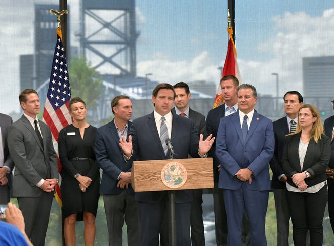 Gov. Ron DeSantis made an announcement at JAX Chamber in September 2019 about statewide financial technology initiatives. JAX Chamber CEO Daniel Davis, who is running for mayor, stands at left.