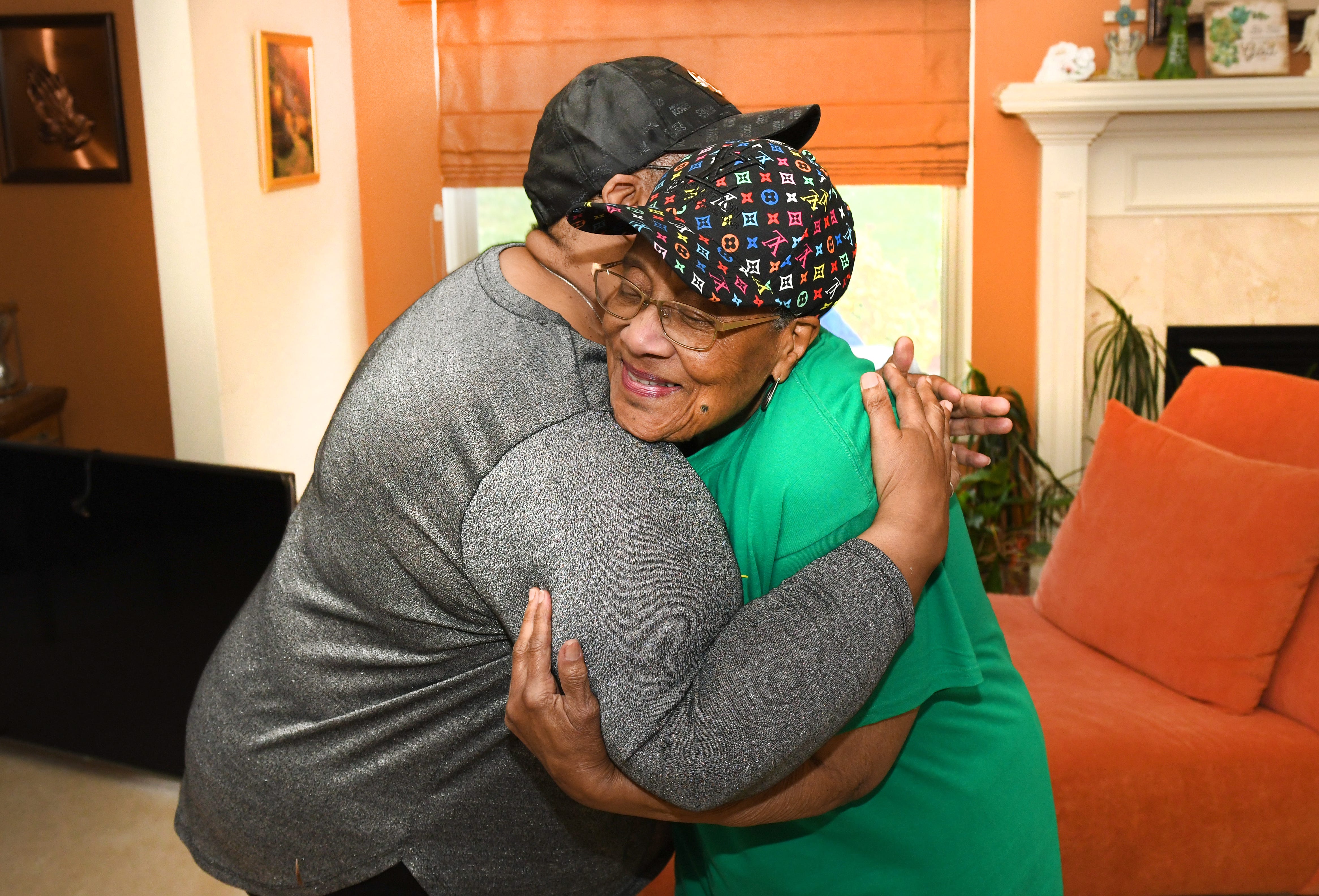 Selina Smith, 63, hugs her mother, Delois McMillan, 85, as she is cared for by her daughter in Pontiac. Smith, is a sandwiched generational caregiver.