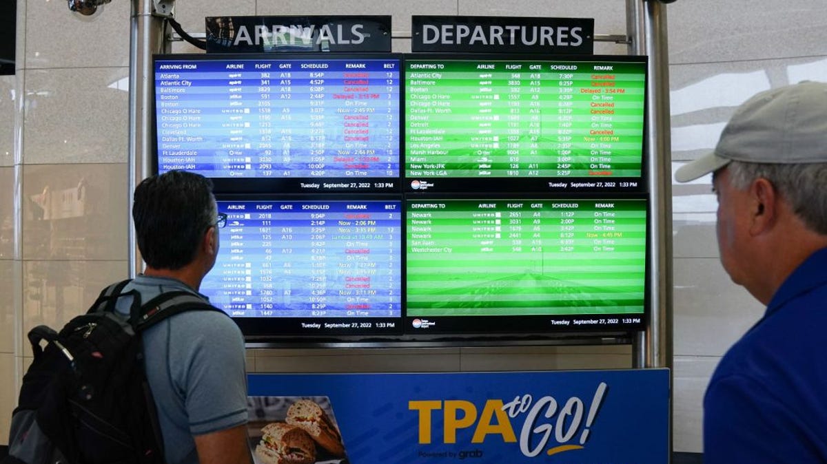 The arrival and departures board listed numerous flight cancelations at Tampa International Airport before the airport closed Tuesday, ahead of Hurricane Ian.