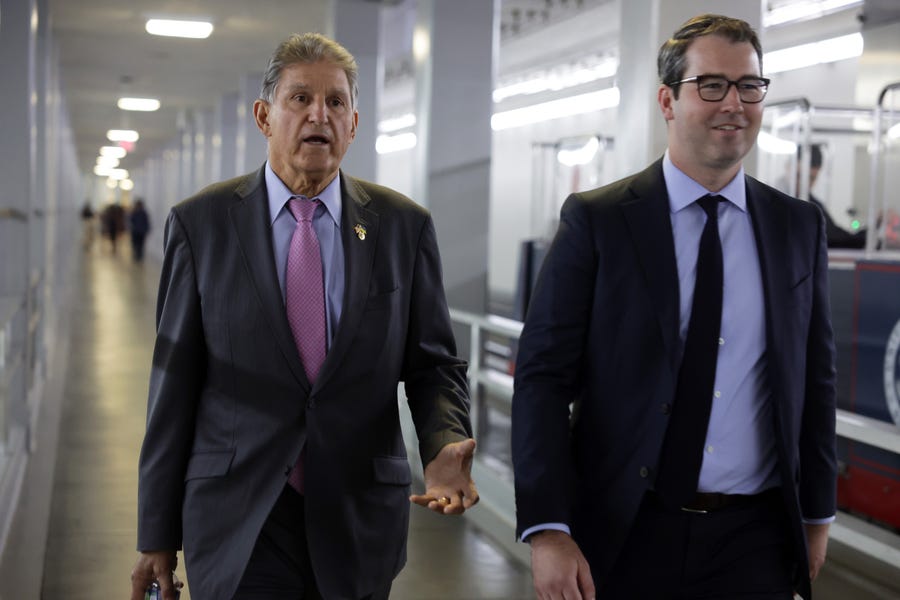 U.S. Sen. Joe Manchin (D-WV) (L) walks in a tunnel prior to a cloture vote on Capitol Hill September 27, 2022 in Washington, DC.