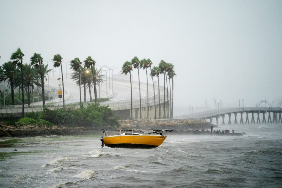 A sail boat is beached  at Sarasota Bay as Hurricane Ian approaches on Sept. 28, 2022 in Sarasota, Fla.