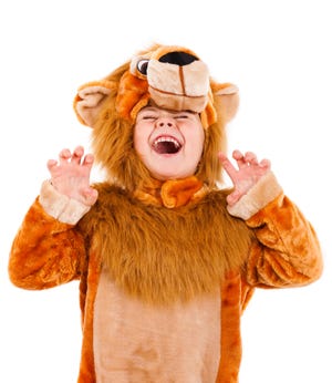 Girl dressed in lion costume.