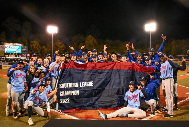 Blue Wahoos players, coaches, support staff gather at home plate at Smokies Stadium after winning the Southern League Championship Wednesday night.