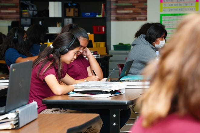 Eighth graders, Allison Garcia (left) and Zaida Davila, work in a classroom that is shared by all of 8th grade at Stanfield Elementary school. The entire 8th grade class shares one classroom due to a teacher shortage.
