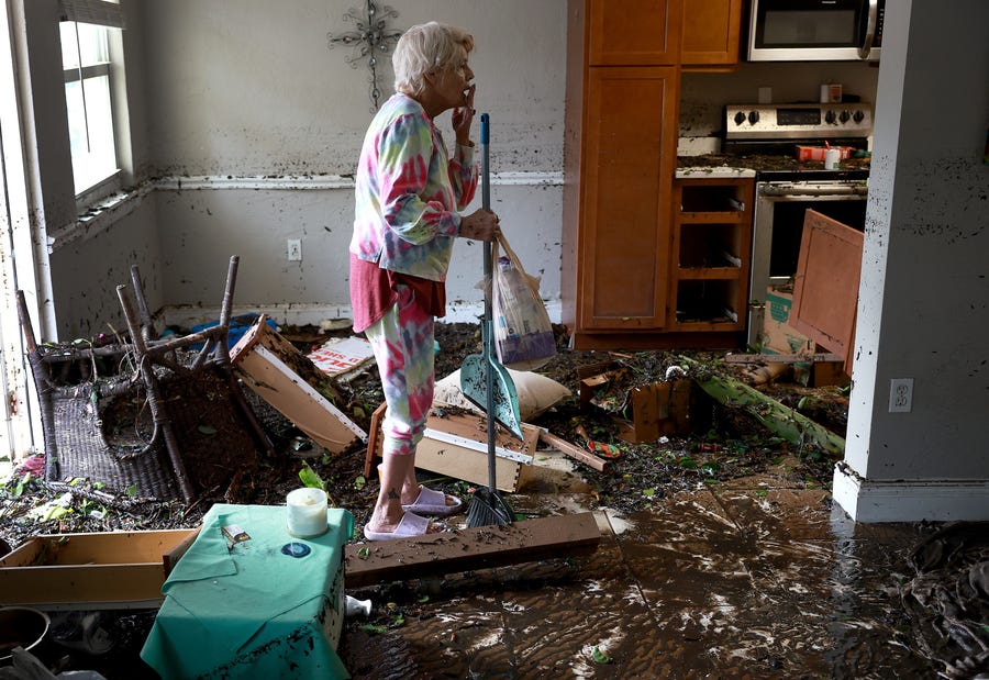 Stedi Scuderi looks over her apartment after flood water inundated it when Hurricane Ian passed through the area on Sept. 29, 2022 in Fort Myers, Fla.