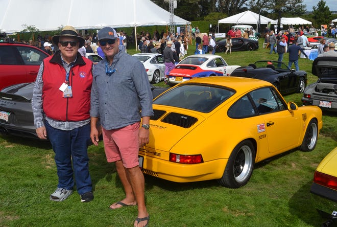 Newport residents Bryan Bardy and Ron O'Hanley pose in front of a custom modified 1987 Porsche Carrera owned by Jamestown friend Chris Cannon Friday during The Gathering at Rough Point in Newport.  It was part of the Audrain Concours + Motor Week.