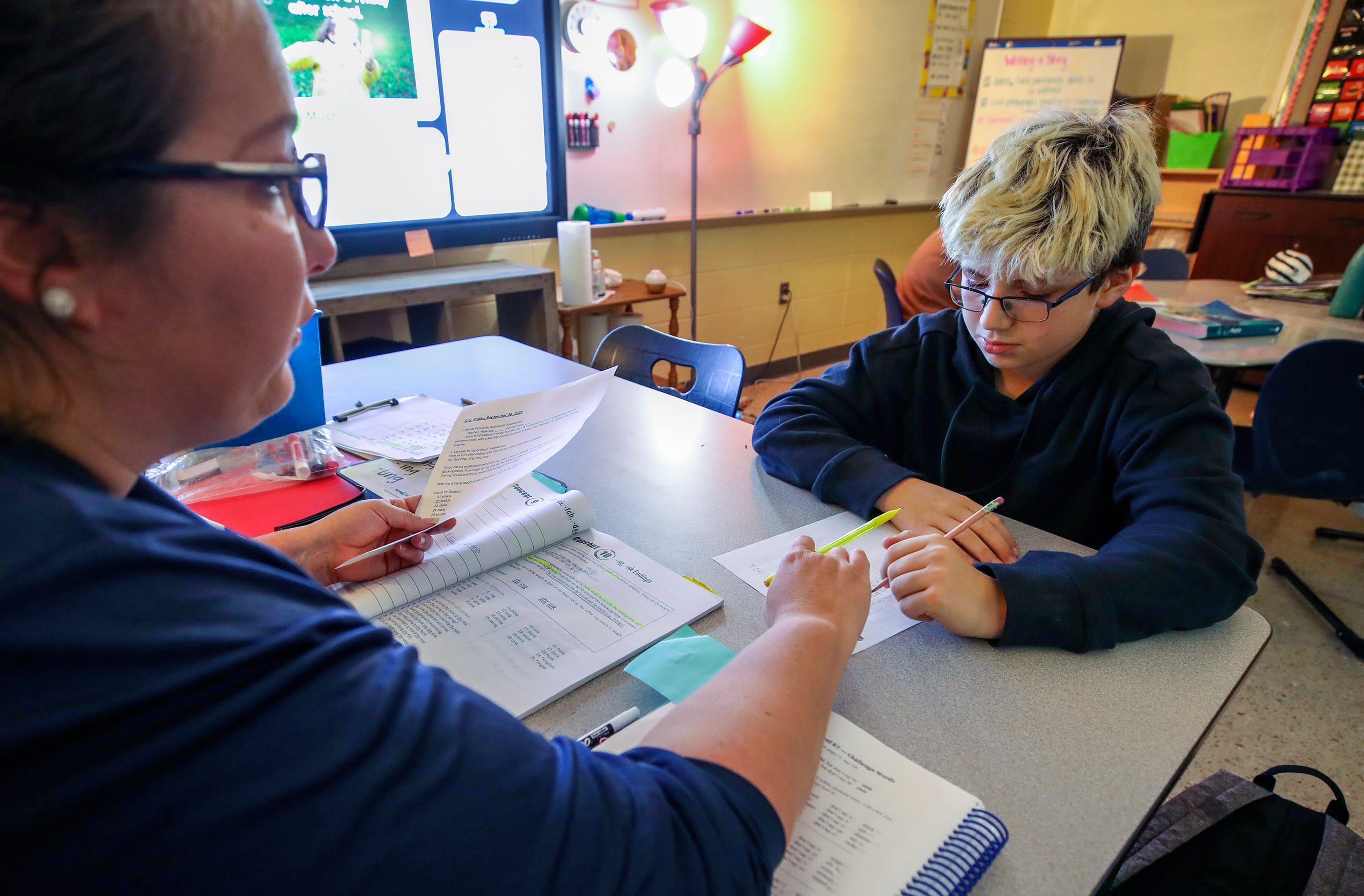 Kaden Farrow works on a reading assessment with ECE teacher Chelsey Curtis in a study skills class at South Oldham Middle School.