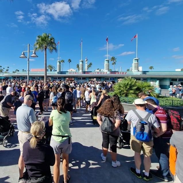 Guests line up outside Disney's Hollywood Studios, which reopened Friday after Hurricane Ian prompted Walt Disney World to close its parks for two days.