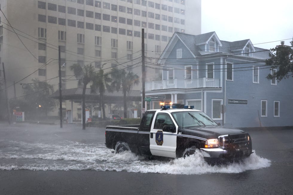 A police vehicle drives through a flooded street as rain from Hurricane Ian inundates the city September 30, 2022 in Charleston, SC Ian hit Florida as a Category 4 storm before crossing the Atlantic and is now striking South Carolina as a Category 1 storm near Charleston.