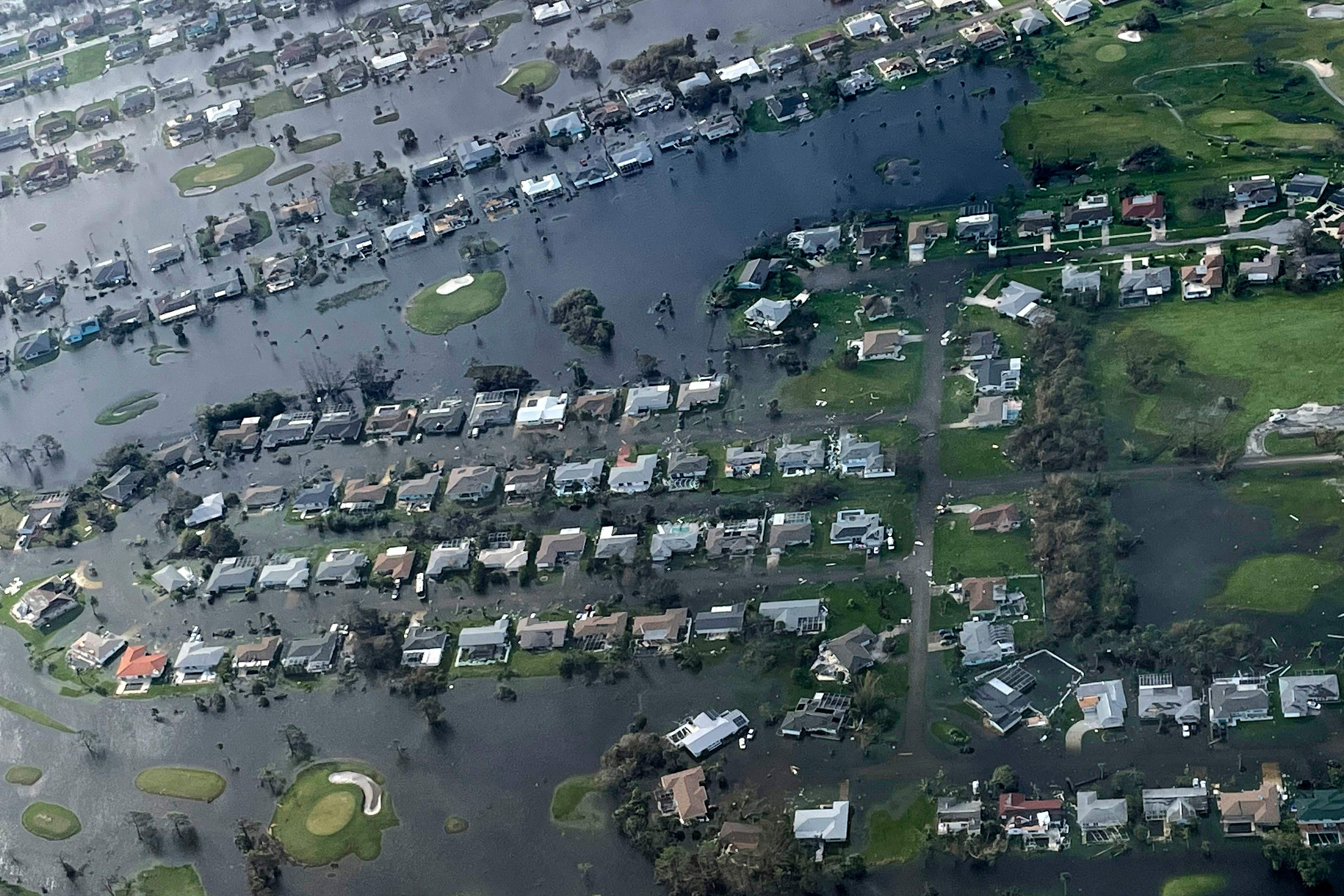 This handout picture courtesy of the US Coast Guard aircrew from Air Station Miami, Florida, shows damage in the aftermath of Hurricane Ian around the Fort Myers area, Florida, on Sept. 29, 2022. - Hurricane Ian left much of coastal southwest Florida in darkness early on Thursday, bringing "catastrophic" flooding that left officials readying a huge emergency response to a storm of rare intensity. The National Hurricane Center said the eye of the "extremely dangerous" hurricane made landfall just after 3:00 pm (1900 GMT) on the barrier island of Cayo Costa, west of the city of Fort Myers.