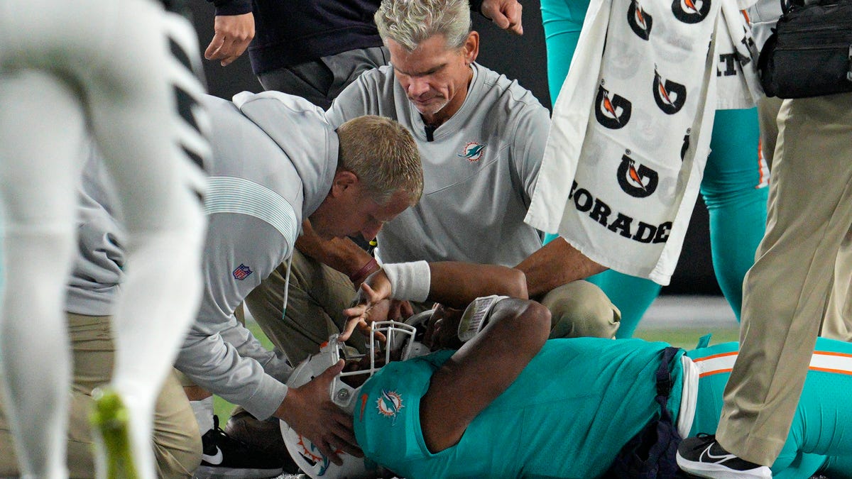 Dolphins quarterback Tua Tagovailoa is examined during Thursday night's game against the Bengals.