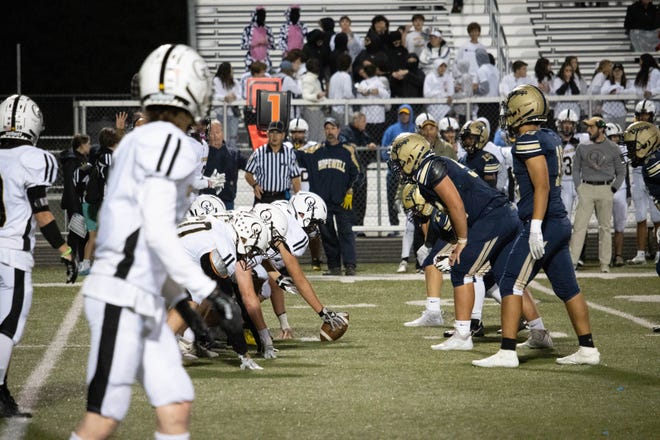 A look down the line of scrimmage ahead of a play between Quaker Valley and Hopewell.