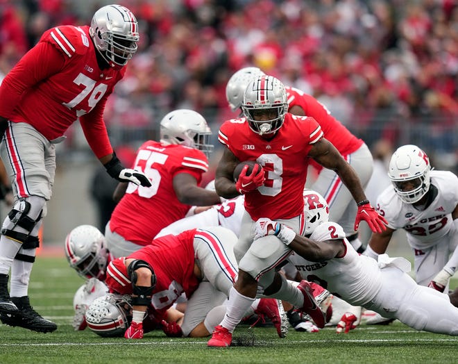 Oct 1, 2022;  Columbus, Ohio, USA;  Ohio State Buckeyes running back Miyan Williams (3) gets past Rutgers Scarlet Knights defensive back Avery Young (2) on run in the third quarter of the NCAA Division I football game between the Ohio State Buckeyes and the Rutgers Scarlet Knights at Ohio Stadium.