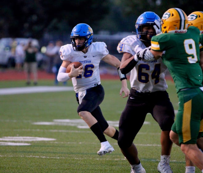 Senior Salthawk quarterback Nic Lange (16) carries the ball 15 yards for the first touchdown of the game, Friday night against the Salina South Cougars at Salina Stadium.