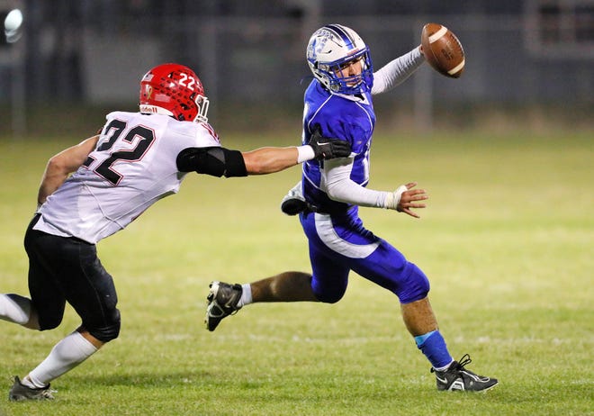 Dundee quarterback Ryan Zanger scrambles away from Clinton's Nate Smith in a game earlier this season. Clinton will play in the state semifinals Saturday.