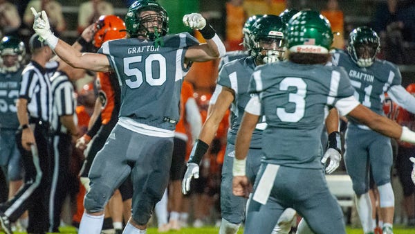 Grafton High School senior Cooper Berube celebrate