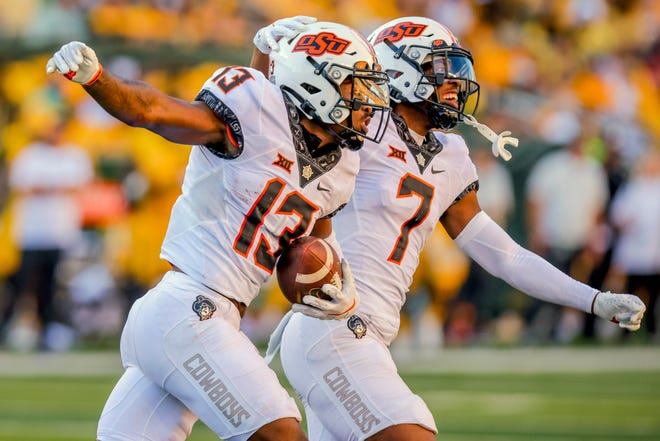 Oklahoma State defenders Thomas Harper (13) and Jabbar Muhammad (7) celebrate an interception during the second half of a 36-25 win at Baylor on Saturday.