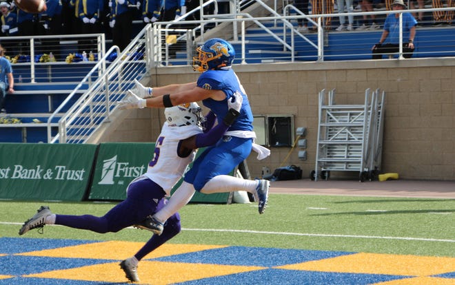 Canyon Bauer of South Dakota State reaches for the ball in the end zone while Bryce Cross defends.