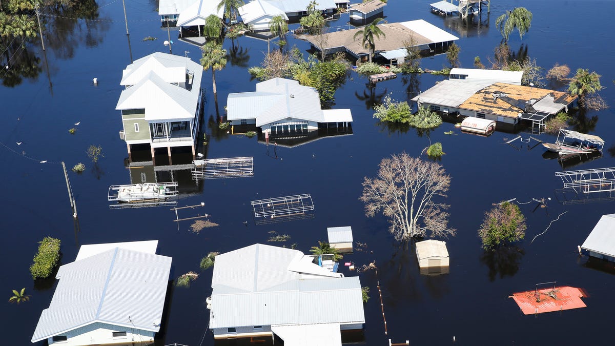 Homes are flooded from the rising waters of the Peace River after Hurricane Ian on Friday, Sept. 30, 2022, in DeSoto County outside Arcadia, Fla.