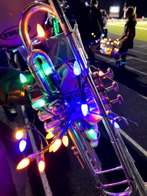A trumpet glows with lights as the Meadowbrook High School Marching Band prepares to take the field for its annual Lights Out performance. The 30-plus year tradition involves the stadium lights being turned out, while the lit up band performs its show. The Colts show this year is entitled True Colors. The band will host its 35th annual Festival of Bands on Saturday, at Eugene Capers Field.