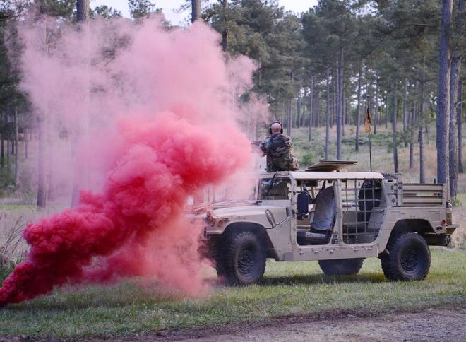 An enemy role player engages Special Forces candidates assigned to the U.S. Army John F. Kennedy Special Warfare Center and School as they assault a target during the final phase of field training known as Robin Sage on April 26, 2022,  in central North Carolina.