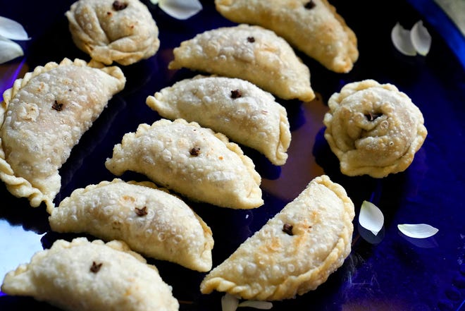 The sweet pastry gughara, part of Diwali celebrations, is carefully folded around a filling.