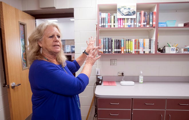 Linda Quinn, an innovation specialist at West Florida High School, talks Monday at the school's media center about the Escambia County Public Schools' plan to have a restricted section with books under appeal for 