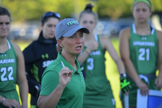 York College field hockey coach Katie Fost speaks to her team during a game. The Spartans are 8-2 after winning their third consecutive contest on Saturday, Oct. 1.