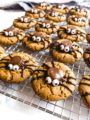 Peanut butter cookies are amazing are topped with Reese's Miniatures for the spider bodies. A add candy eyes and chocolate spider legs, for a Halloween treat.