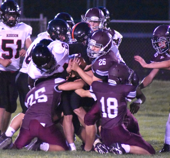 The Union City JV defense, led by Brendan Labar (26) and Carson Danke (25) tackle and Addison ball carrier on Monday night