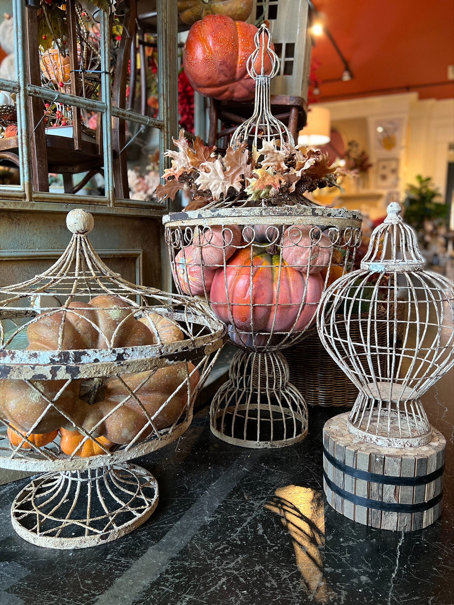 A series of cloches featuring gourds of all shapes and sizes.