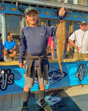 Valen Womack, 11, got on the leaderboard with this 10.4-pound scamp caught aboard the 100 Proof with Capt. Allen Staples on Day 3 of the Destin Fishing Rodeo.
