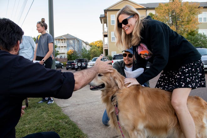Father Ben Williams blesses seven-year-old Fox as his owners, Harrison Smith and Anne Freeman, watch while holding Fox during the Blessing of the Animals event next to the Jackson Downtown Dog Walk on Tuesday, October 4, 2022, in Jackson, Tennessee. The event was put on by Mission Saint James, which is a mission of All Saints Anglican Church. Williams said he wanted to hold the event because October 4 is the Feast of St. Francis of Assisi and St. Francis, “loved creation, loved God’s creatures and His animals,” Williams said. “So this is a fun tradition in the Anglican Church of blessing pets.”  