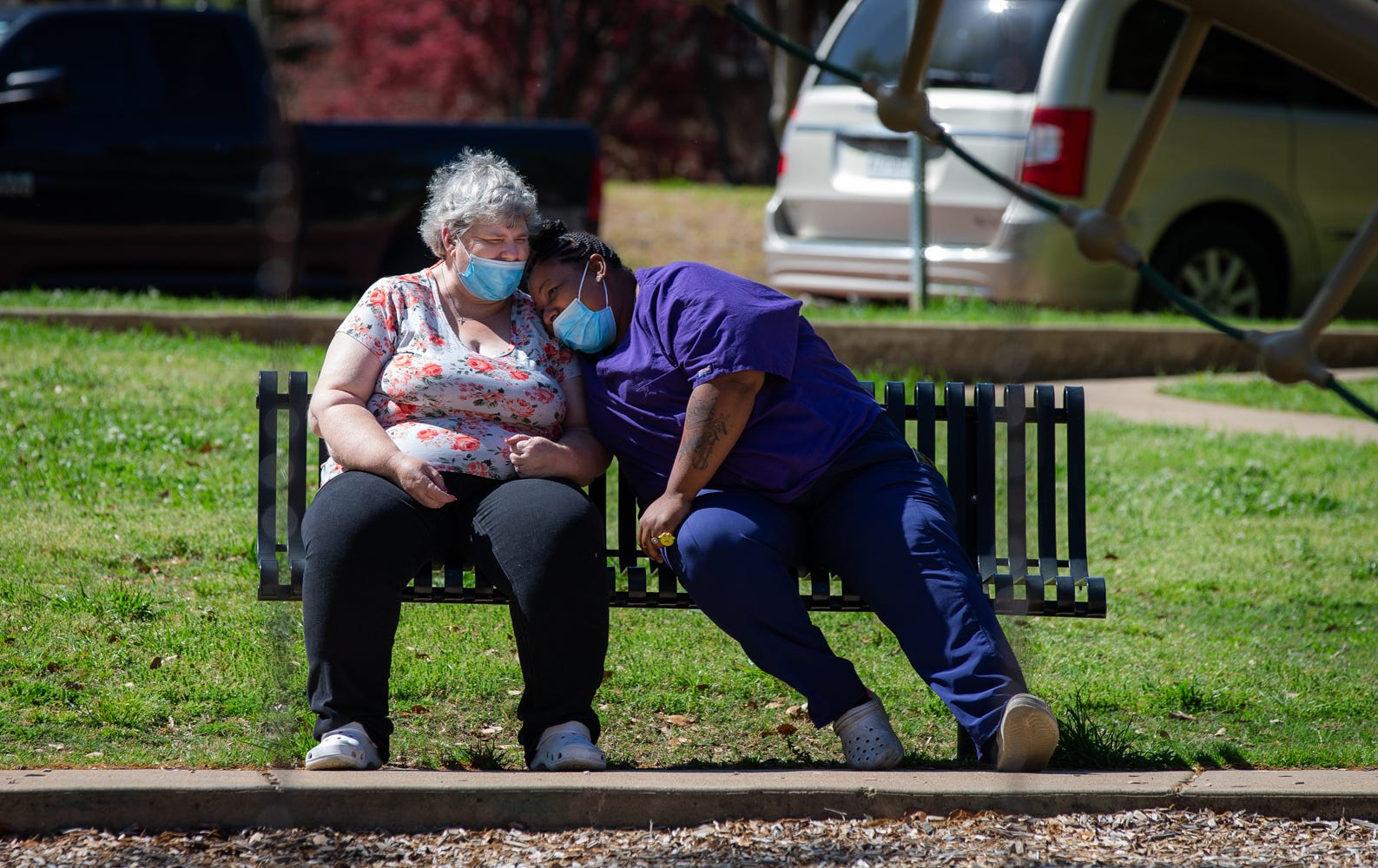 Caregiver Tre'Asia Anderson shares a laugh with client Constance while relaxing at Bergfeld Park in Tyler on April 6.