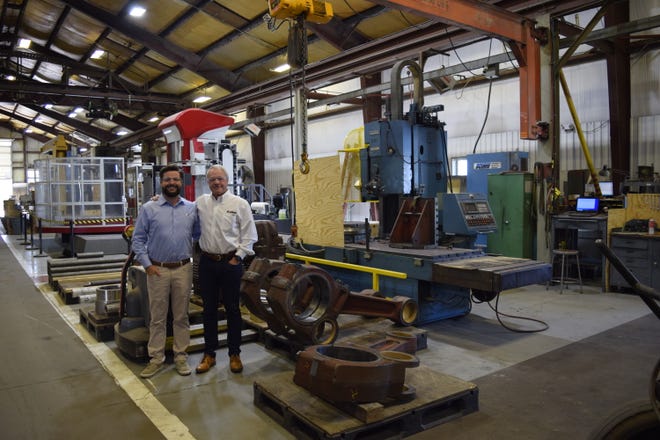 Son and father Will Exline, left, and Rob Exline stand in the main shop at the Exline company in Salina. The two represent the fifth and sixth generations of the family that has owned the evolving business for 150 years.