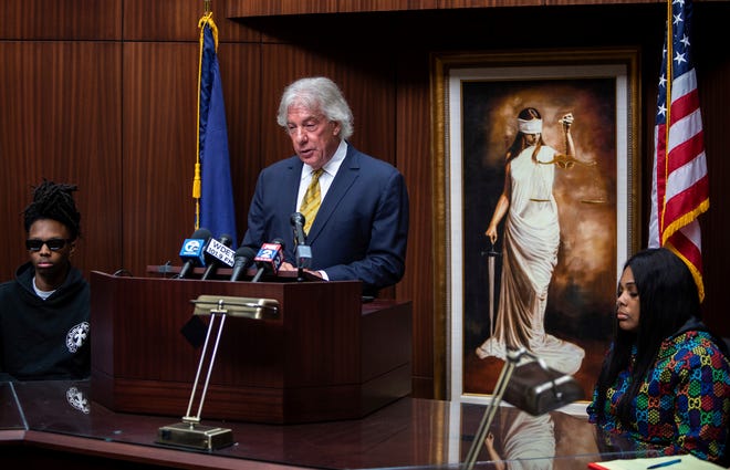 Geoffrey Fieger speaks in front of media members as Porter Burks' mother, Quieauna Wilson sits next to Fieger during a press conference inside Fieger Law in Southfield on Oct. 6, 2022.