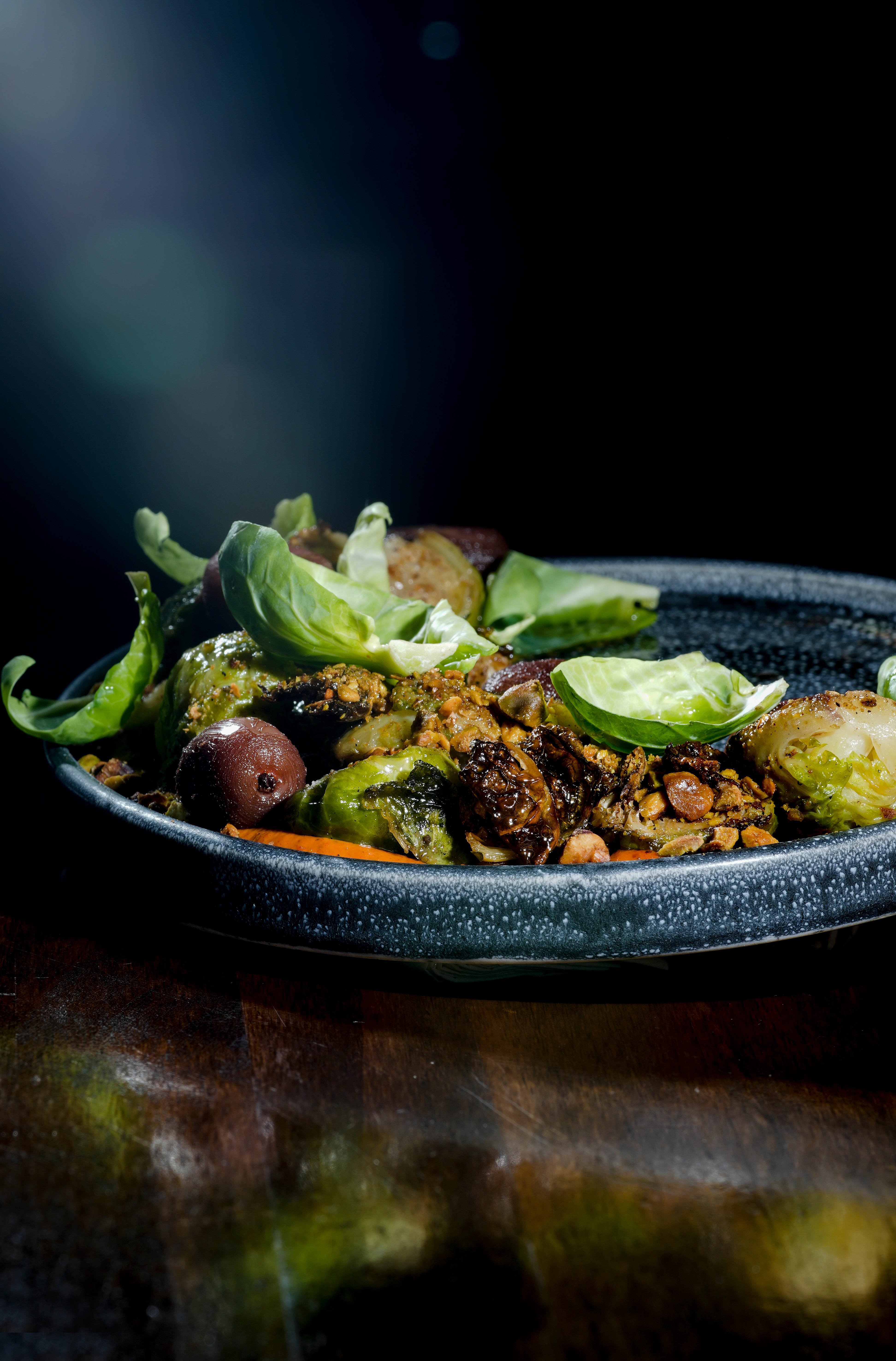 Wood-fired brussels sprouts with ras el hanout, pistachio, muhammara and balsamic roasted grapes is an autumn dish at Odd Duck in Walker's Point.